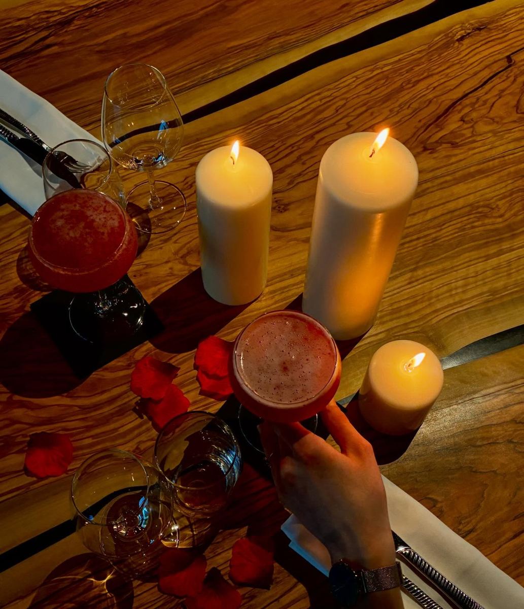Table aux chandelles et verres de vin rouge